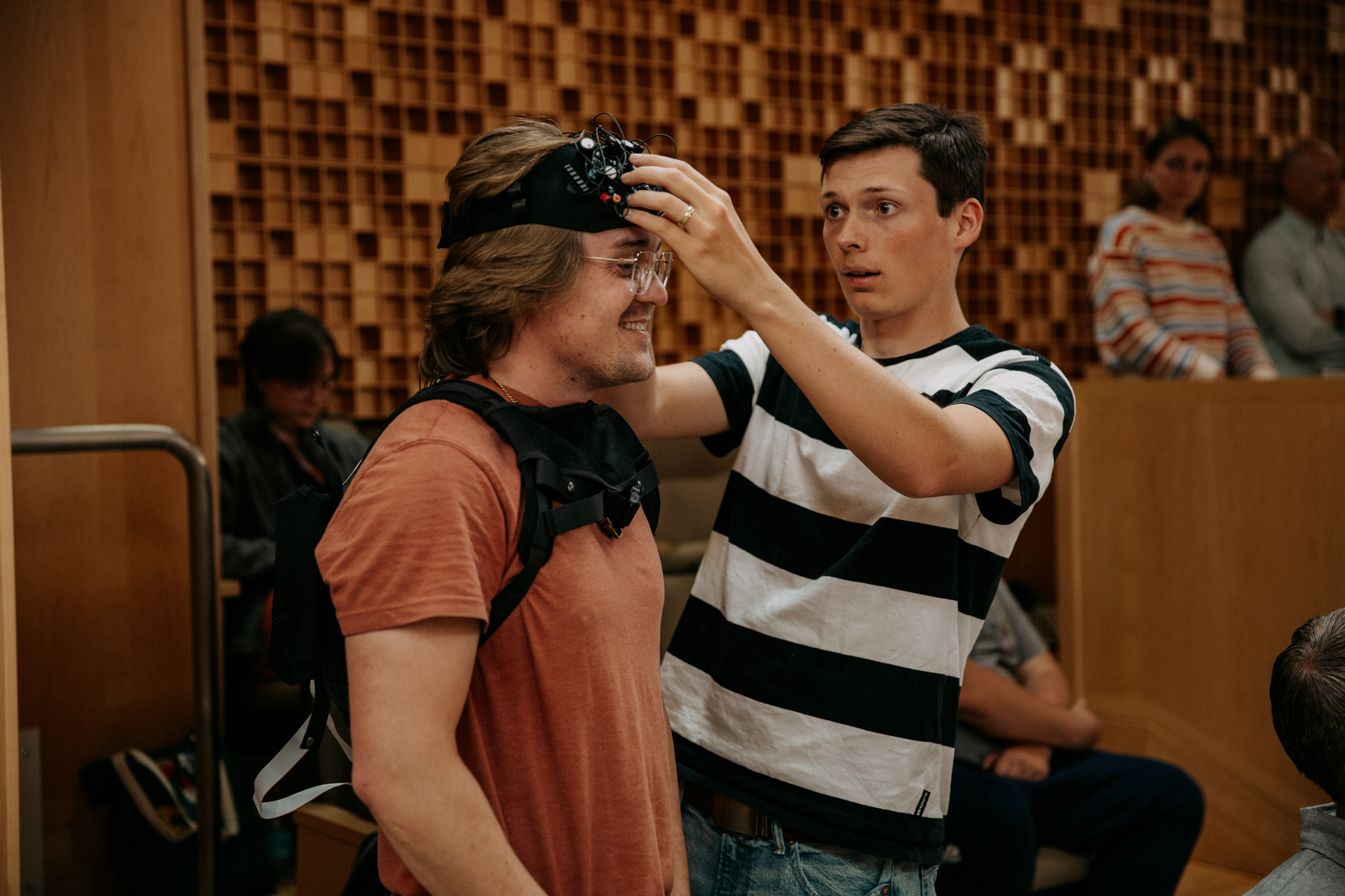 Student puts on equipment to record and read brain activity.