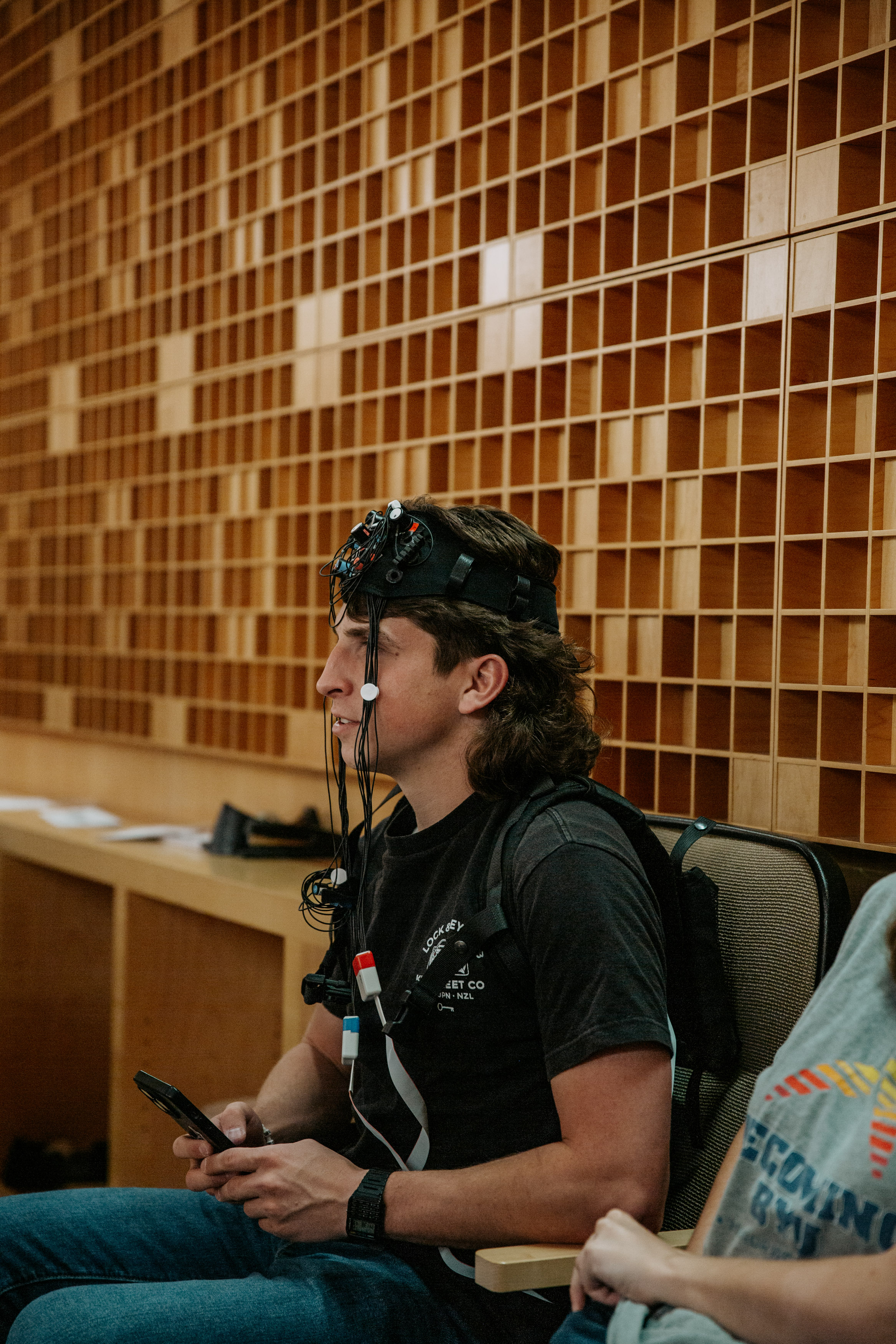 Audience member wears equipment to record brain activity.