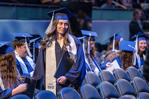 a byu graduate holds a diploma in the Marriott Center