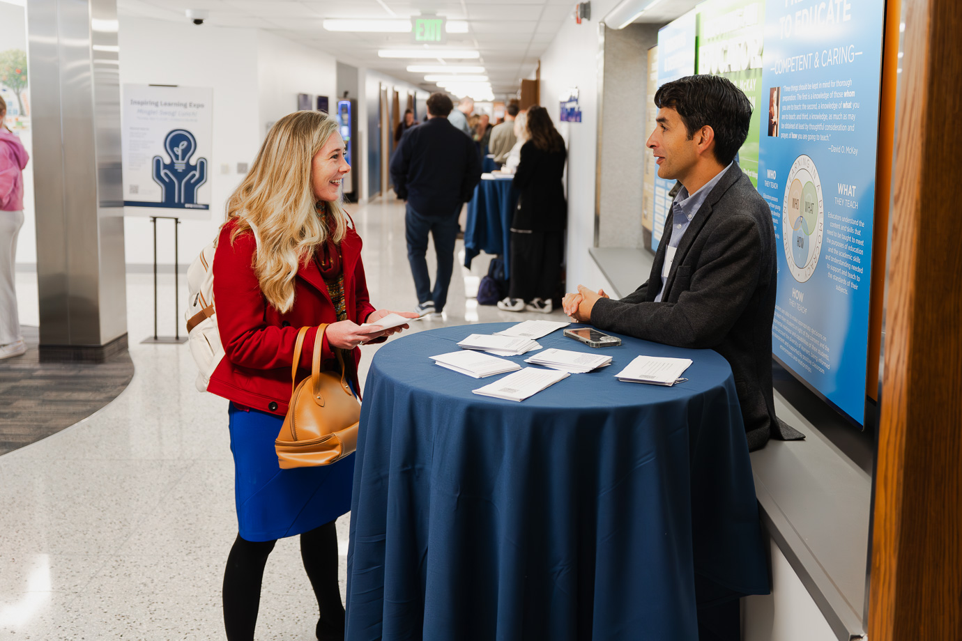 Two people talking at an alumni event