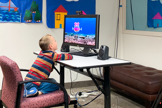 boy watching a tv with a fish animation