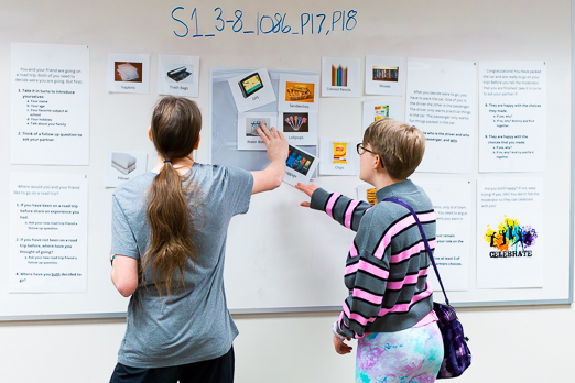 two people collaborating over a whiteboard