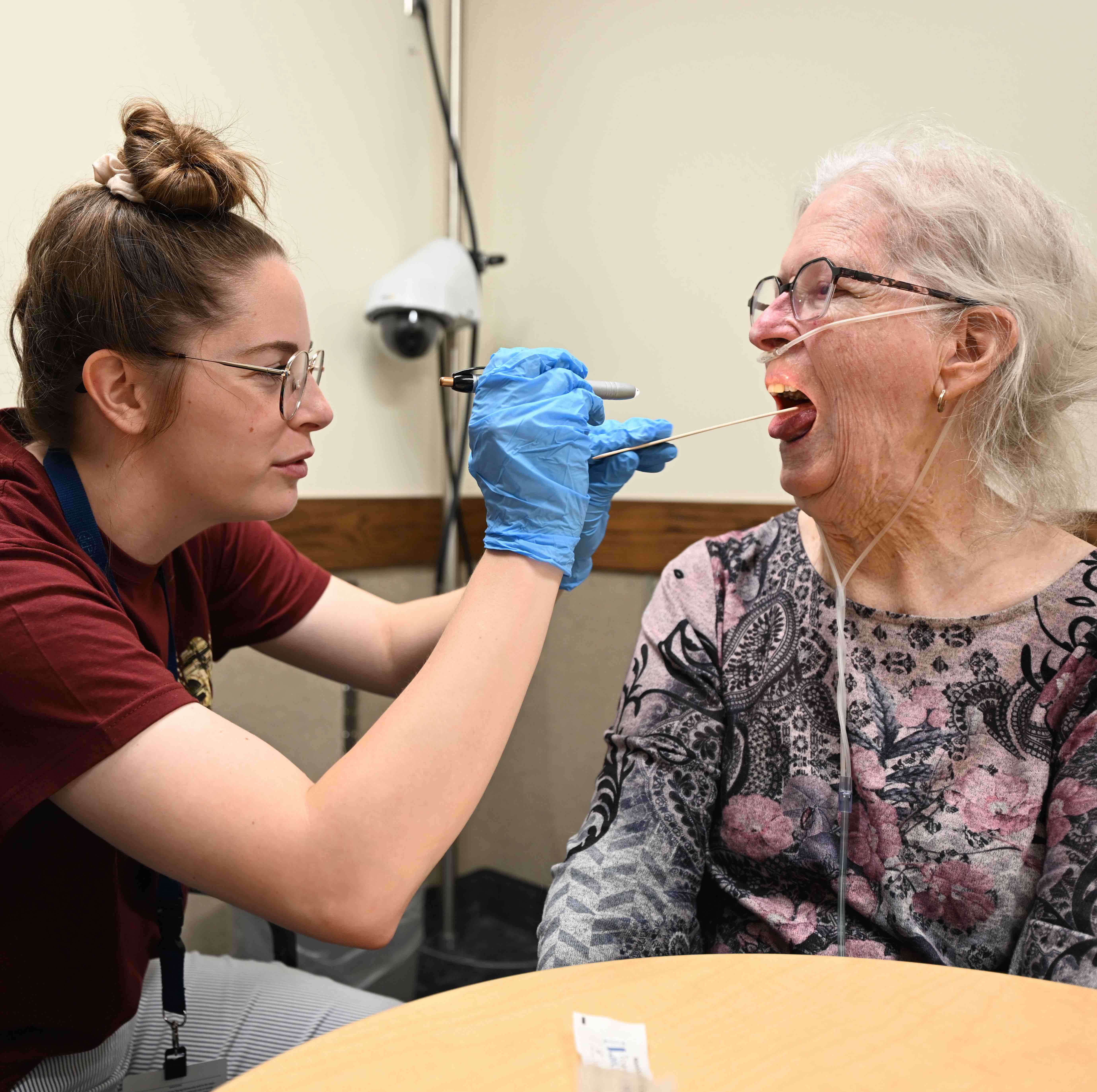 A doctor helping an elderly patient