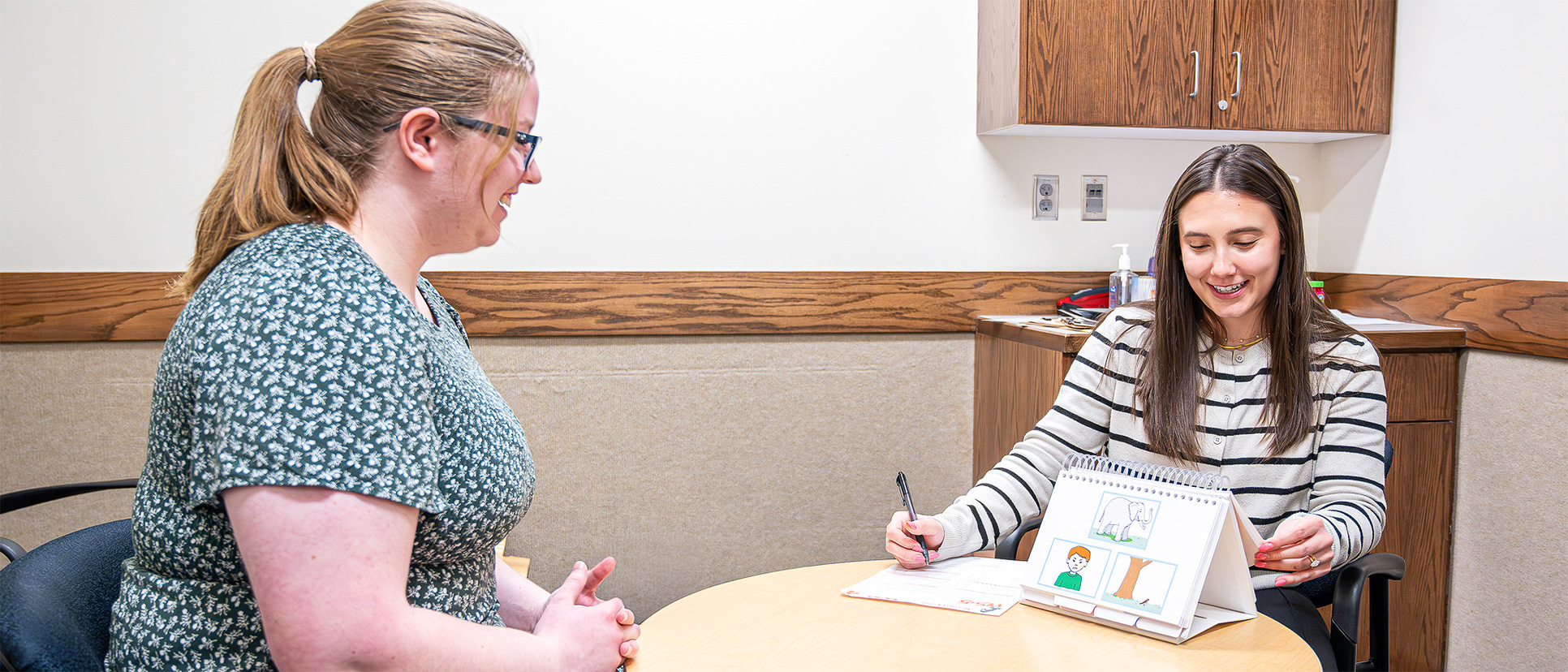 Two female students engage in speech pathology research