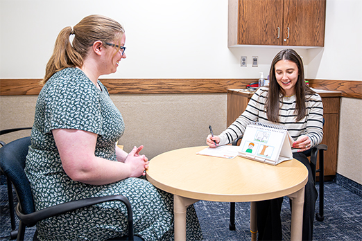 Two female students engage in speech pathology research