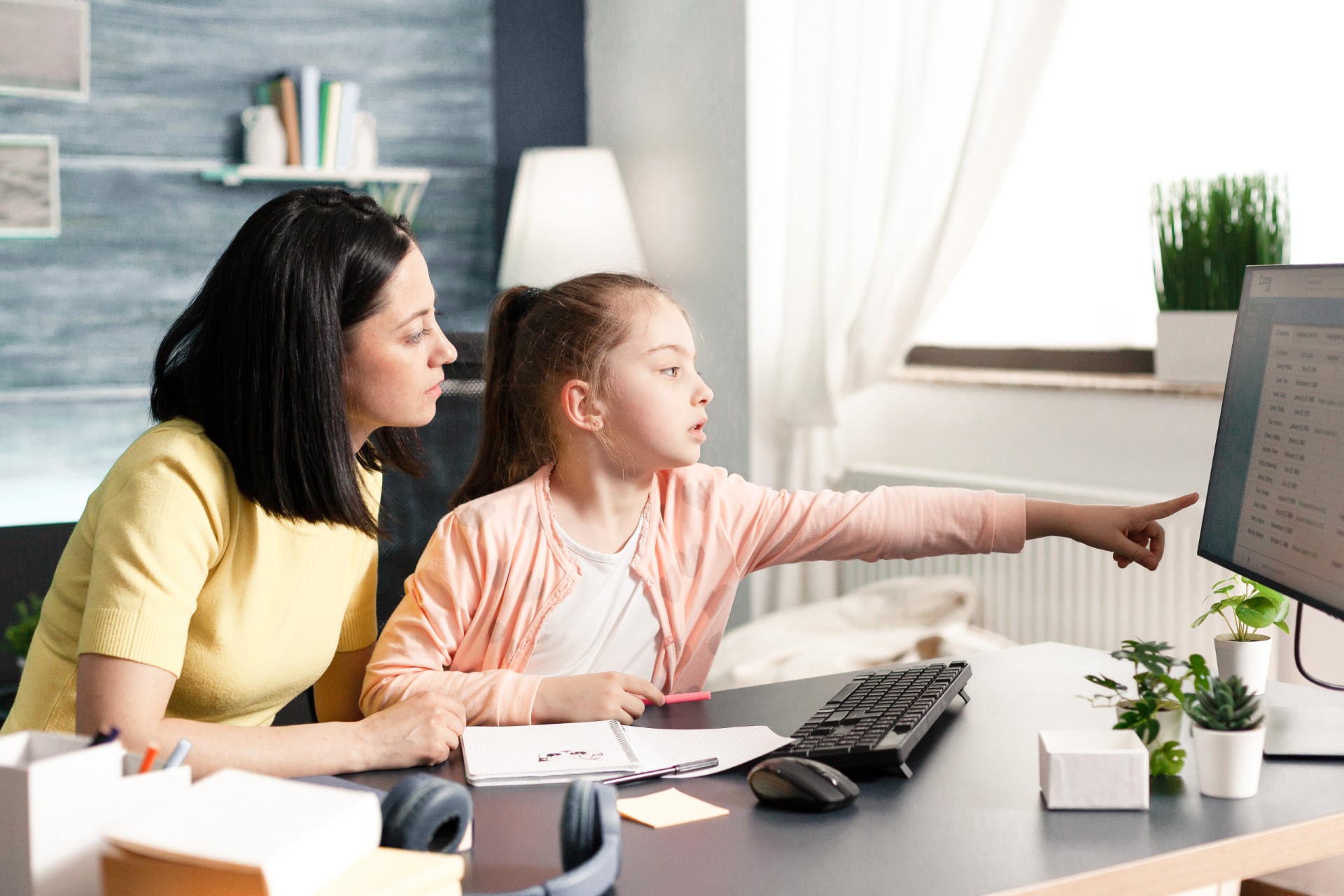 Woman and child looking at computer screen