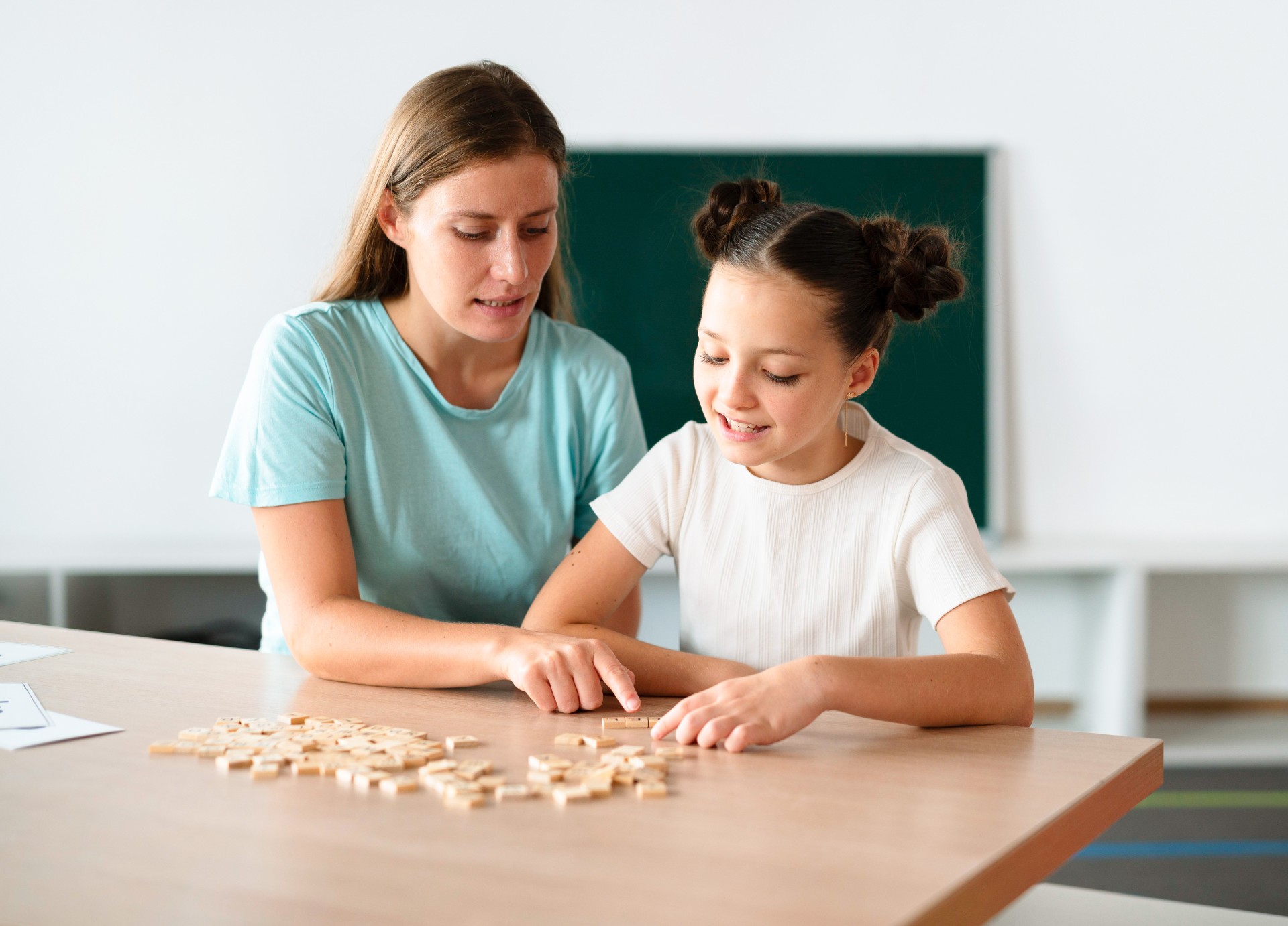 Woman and child playing with toys on table