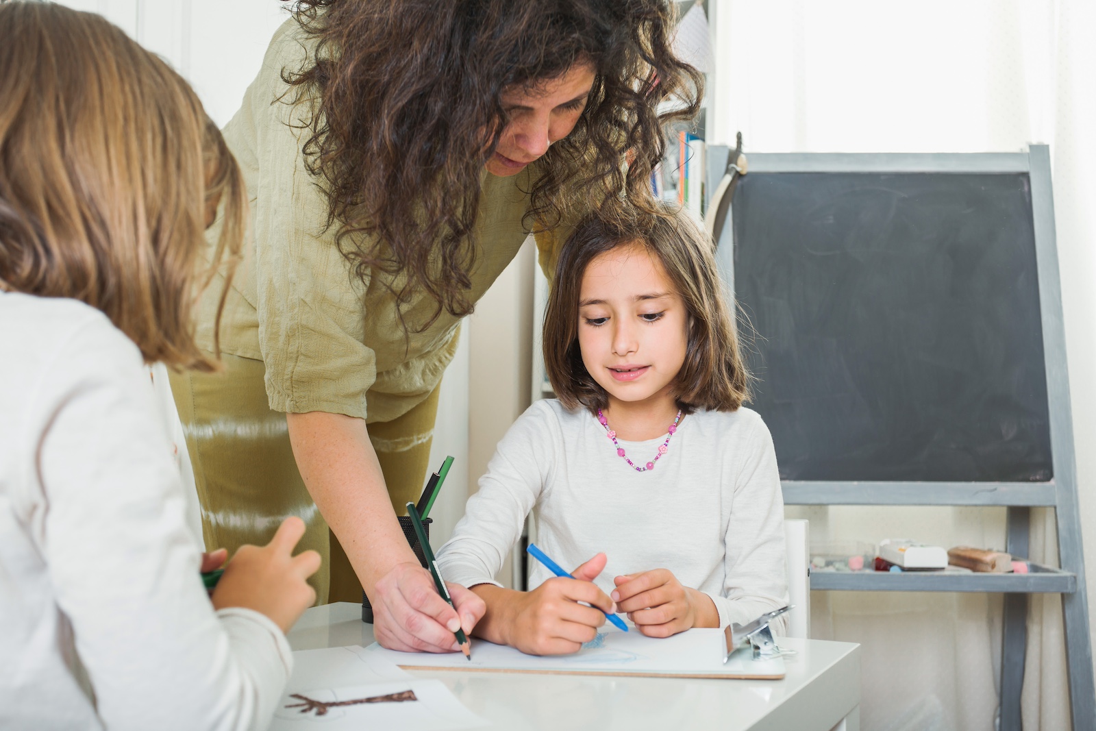 Teacher helping student with assignment