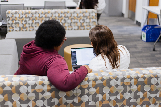 Two women learning from a laptop