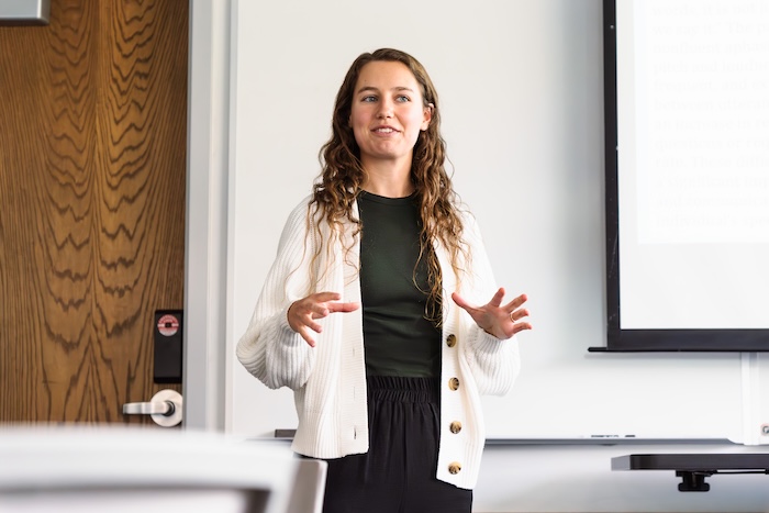 Woman standing and teaching at front of classroom
