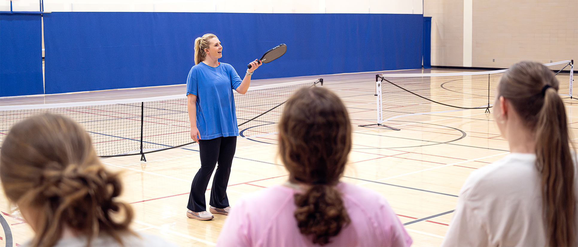 a female student teaches a Physical Education course
