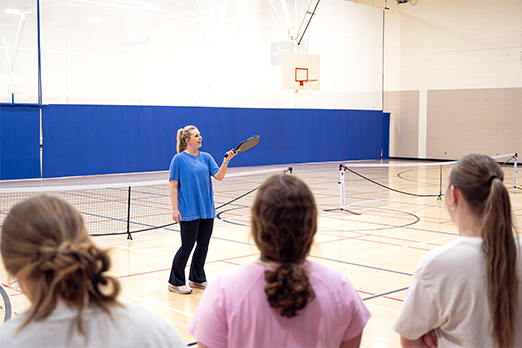 a female student teaches a Physical Education course