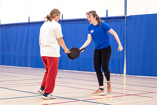 Female students celebrate a point scored during a game